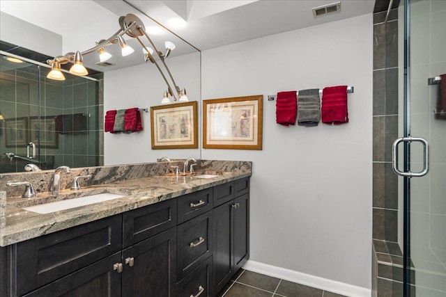 1534 Mcdaniels Ave Unit 4B, Highland Park, IL 60035 - bathroom featuring double vanity, tile patterned floors, a stall shower, and baseboards