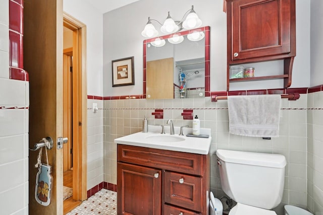 7517 N Oketo Ave, Chicago, IL 60631 - bathroom featuring vanity, tile walls, toilet, and a wainscoted wall