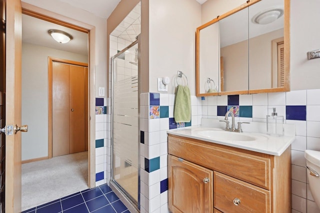 7517 N Oketo Ave, Chicago, IL 60631 - full bathroom with a shower stall, tile walls, vanity, tile patterned floors, and toilet
