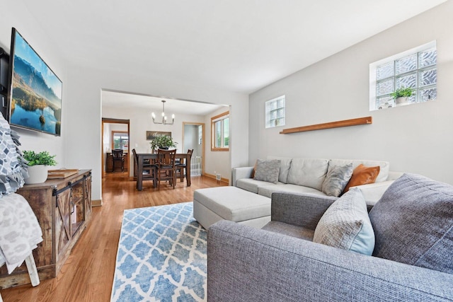 7517 N Oketo Ave, Chicago, IL 60631 - living room with a chandelier, light wood-style floors, and baseboards
