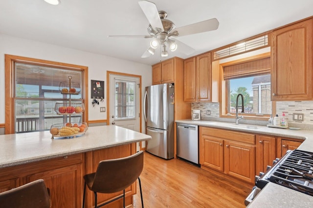 7517 N Oketo Ave, Chicago, IL 60631 - kitchen featuring stainless steel appliances, a sink, ceiling fan, and healthy amount of natural light