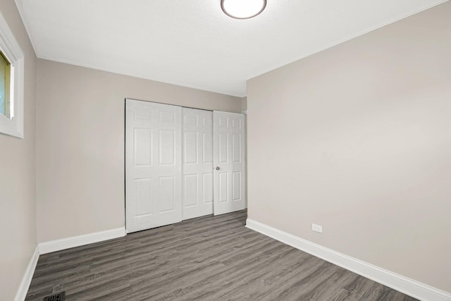 232 Camden Dr, Steger, IL 60475 - unfurnished bedroom with wood finished floors, baseboards, and a closet