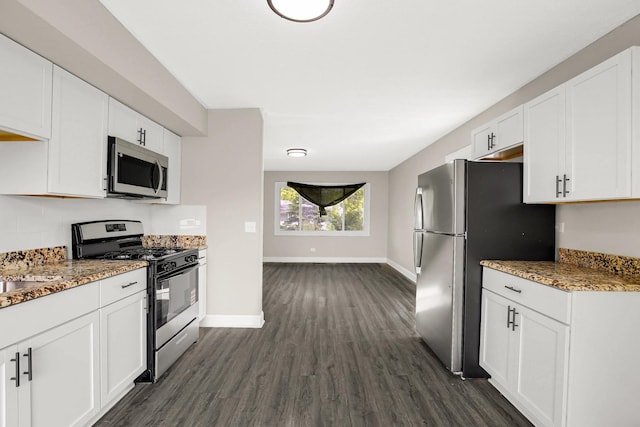 232 Camden Dr, Steger, IL 60475 - kitchen with stainless steel appliances, dark wood-style flooring, baseboards, and white cabinets