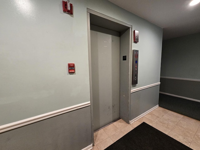 5600 Hillcrest Ln Unit 2L, Lisle, IL 60532 - hallway featuring light tile patterned flooring and elevator