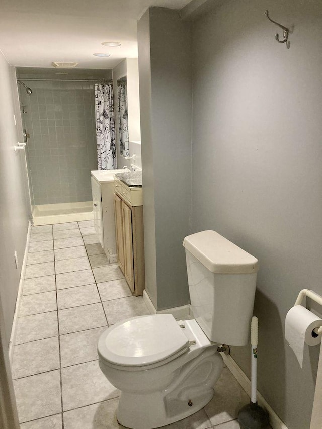 5352 N Magnet Ave, Chicago, IL 60630 - bathroom featuring toilet, tile patterned floors, vanity, a shower with curtain, and baseboards