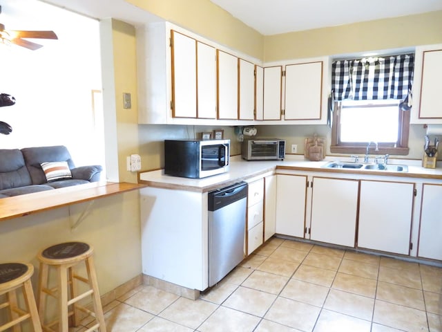 2020 Greengold St, Crest Hill, IL 60403 - kitchen with appliances with stainless steel finishes, a sink, light countertops, light tile patterned floors, and white cabinetry