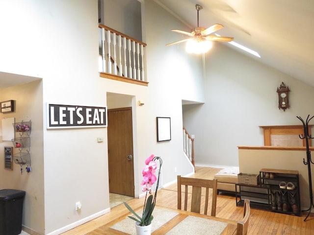 2020 Greengold St, Crest Hill, IL 60403 - dining area with high vaulted ceiling, a ceiling fan, light wood-style floors, stairs, and baseboards