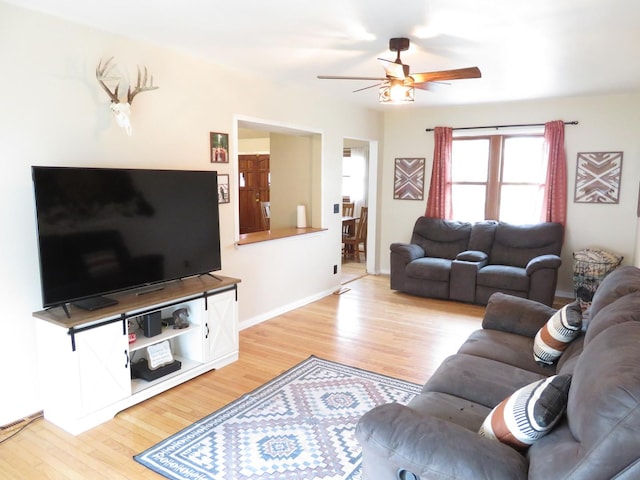 2020 Greengold St, Crest Hill, IL 60403 - living room featuring a ceiling fan, light wood-style flooring, and baseboards
