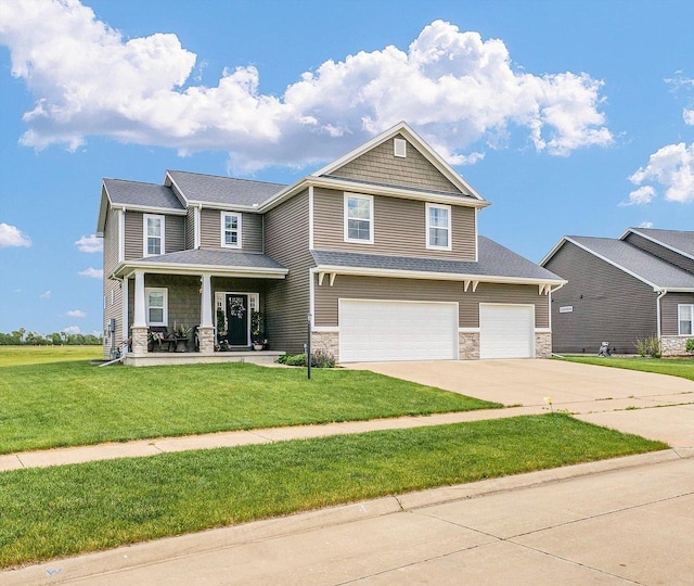 1908 Littlefield Ln, Mahomet, IL 61853 - craftsman-style house with stone siding, an attached garage, driveway, and a front yard