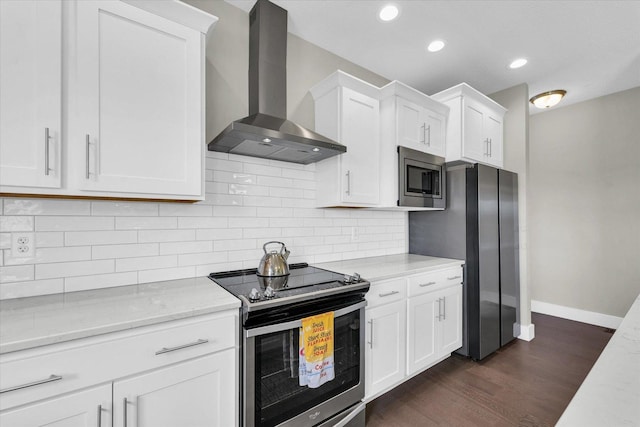 1908 Littlefield Ln, Mahomet, IL 61853 - kitchen with wall chimney exhaust hood, appliances with stainless steel finishes, dark wood-type flooring, baseboards, and white cabinets