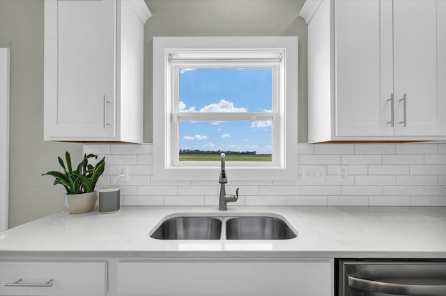 1908 Littlefield Ln, Mahomet, IL 61853 - kitchen featuring a sink, stainless steel dishwasher, white cabinetry, and tasteful backsplash