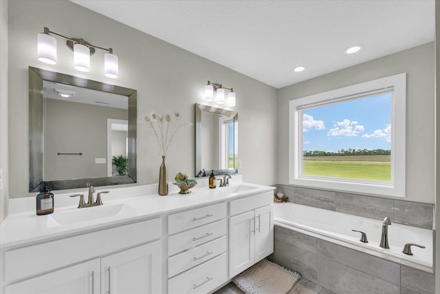 1908 Littlefield Ln, Mahomet, IL 61853 - bathroom with double vanity, a garden tub, and recessed lighting