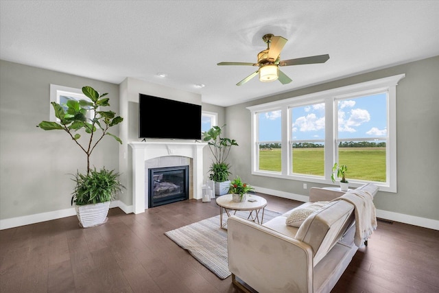1908 Littlefield Ln, Mahomet, IL 61853 - living area featuring baseboards, a tile fireplace, wood finished floors, a ceiling fan, and a textured ceiling