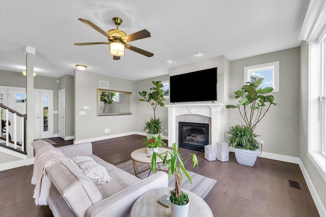 1908 Littlefield Ln, Mahomet, IL 61853 - living room with dark wood-type flooring, baseboards, a glass covered fireplace, and ceiling fan