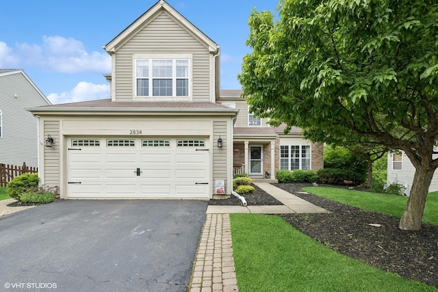 2834 Forestview Dr, Carpentersville, IL 60110 - traditional-style house featuring driveway, a garage, and a front yard