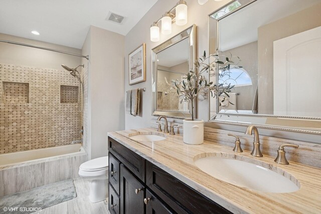 2834 Forestview Dr, Carpentersville, IL 60110 - full bathroom featuring tiled shower / bath, toilet, and double vanity