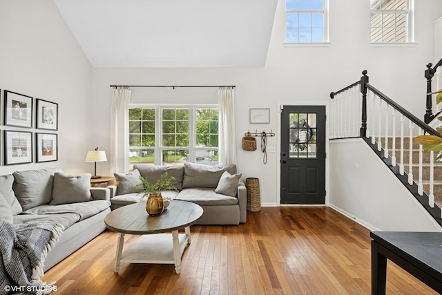 2834 Forestview Dr, Carpentersville, IL 60110 - living room featuring high vaulted ceiling, healthy amount of natural light, wood-type flooring, stairway, and baseboards