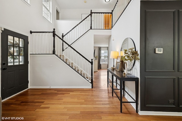 2834 Forestview Dr, Carpentersville, IL 60110 - entrance foyer with stairway, a towering ceiling, wood finished floors, and baseboards