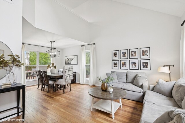 2834 Forestview Dr, Carpentersville, IL 60110 - living room featuring a chandelier and light wood-style floors