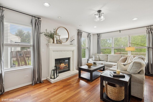 2834 Forestview Dr, Carpentersville, IL 60110 - living area featuring light wood-type flooring, a brick fireplace, recessed lighting, and baseboards