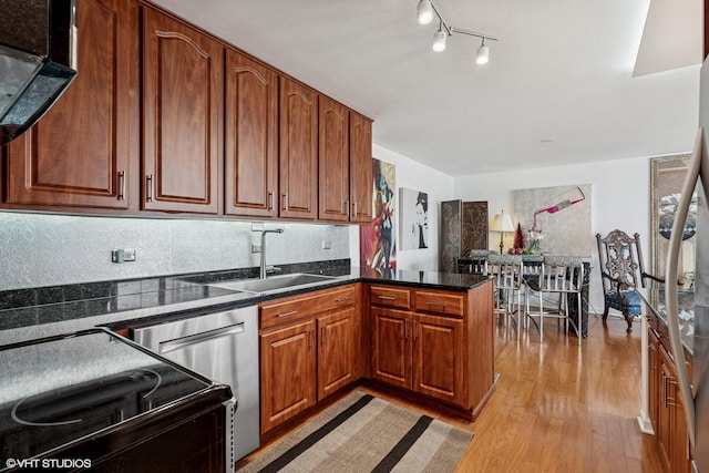 505 N Lake Shore Dr Unit 5201, Chicago, IL 60611 - kitchen featuring a peninsula, light wood-style flooring, a sink, stainless steel dishwasher, and brown cabinetry