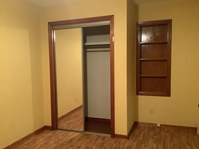 404 W Francis Rd, New Lenox, IL 60451 - unfurnished bedroom with wood finished floors, a closet, and baseboards
