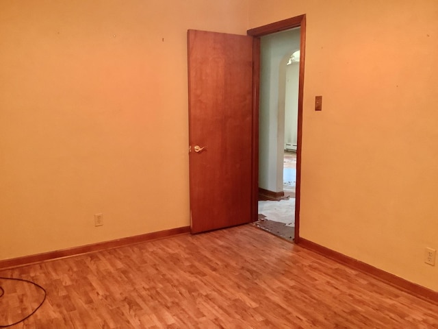 404 W Francis Rd, New Lenox, IL 60451 - unfurnished room featuring wood finished floors, a baseboard heating unit, and baseboards