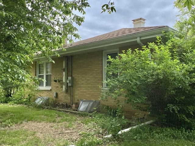 404 W Francis Rd, New Lenox, IL 60451 - view of side of home featuring brick siding, a shingled roof, and a chimney