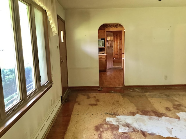 404 W Francis Rd, New Lenox, IL 60451 - spare room with arched walkways, baseboards, and a baseboard radiator