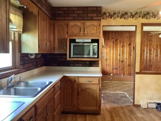 404 W Francis Rd, New Lenox, IL 60451 - kitchen featuring stainless steel microwave, light wood finished floors, a baseboard heating unit, light countertops, and a sink