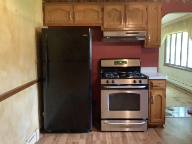 404 W Francis Rd, New Lenox, IL 60451 - kitchen featuring under cabinet range hood, stainless steel gas range oven, freestanding refrigerator, a baseboard heating unit, and light countertops