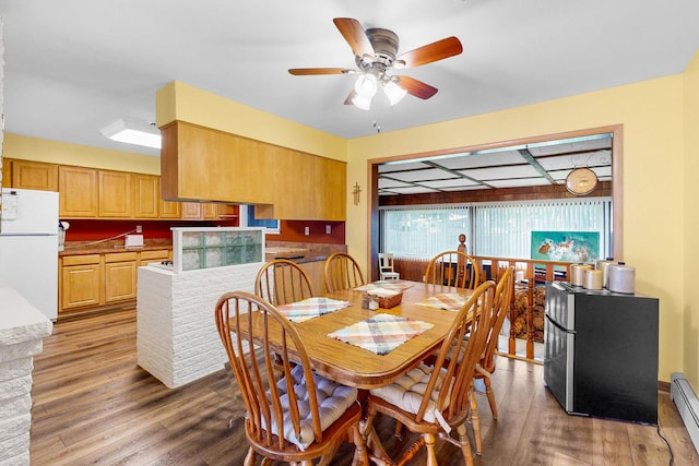 143 Scott Dr, East Dundee, IL 60118 - dining space featuring wood finished floors, a ceiling fan, and a baseboard radiator