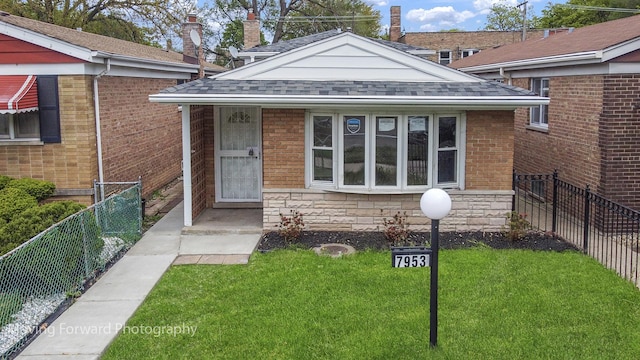 7953 S Stewart Ave, Chicago, IL 60620 - view of exterior entry featuring roof with shingles and brick siding