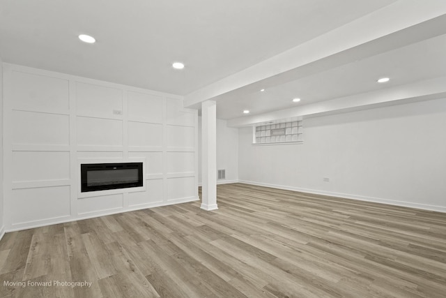 7953 S Stewart Ave, Chicago, IL 60620 - unfurnished living room with light wood finished floors, recessed lighting, baseboards, and a glass covered fireplace