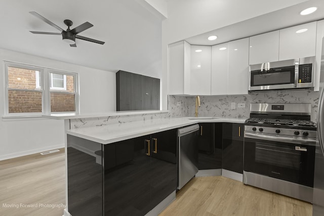 7953 S Stewart Ave, Chicago, IL 60620 - kitchen featuring stainless steel appliances, a sink, modern cabinets, a peninsula, and white cabinetry