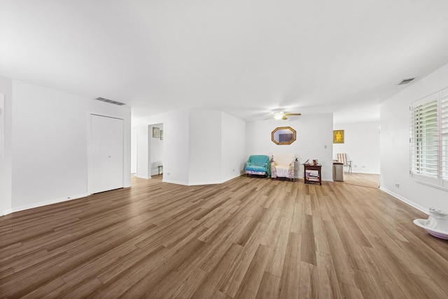 2625 Essington Rd Unit 2625, Joliet, IL 60435 - unfurnished living room featuring ceiling fan, light wood finished floors, and baseboards