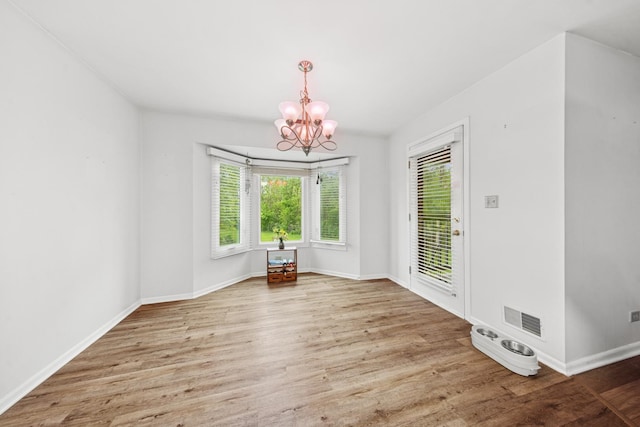 2625 Essington Rd Unit 2625, Joliet, IL 60435 - unfurnished dining area featuring a chandelier, wood finished floors, and baseboards