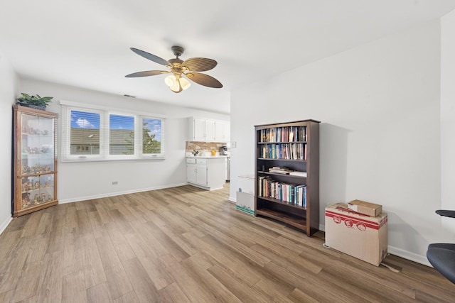 2625 Essington Rd Unit 2625, Joliet, IL 60435 - living room with a ceiling fan, light wood-type flooring, and baseboards