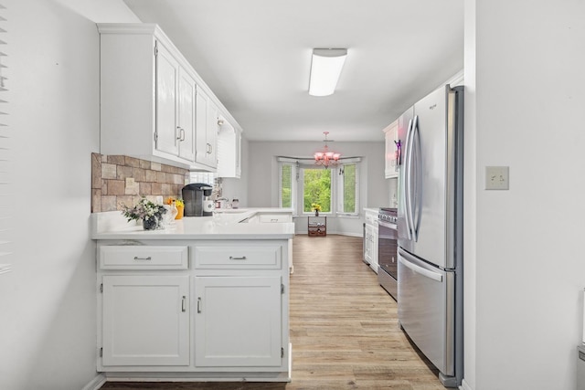 2625 Essington Rd Unit 2625, Joliet, IL 60435 - kitchen with appliances with stainless steel finishes, a peninsula, light wood-style flooring, and white cabinets