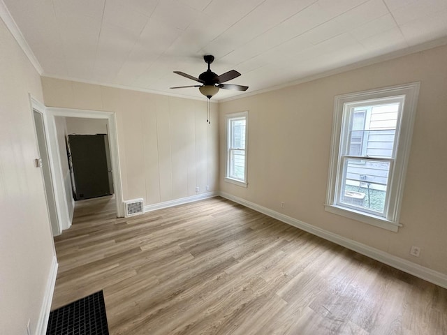 964 S Washington Ave, Kankakee, IL 60901 - unfurnished room featuring crown molding, light wood-style flooring, ceiling fan, and baseboards