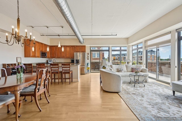170 N NW Hwy Unit 401, Park Ridge, IL 60068 - living room featuring light wood-style flooring and a chandelier