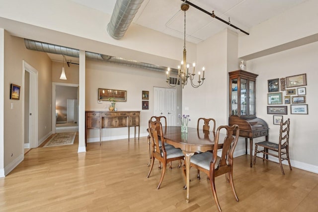 170 N NW Hwy Unit 401, Park Ridge, IL 60068 - dining room with light wood-type flooring, a chandelier, baseboards, and a high ceiling
