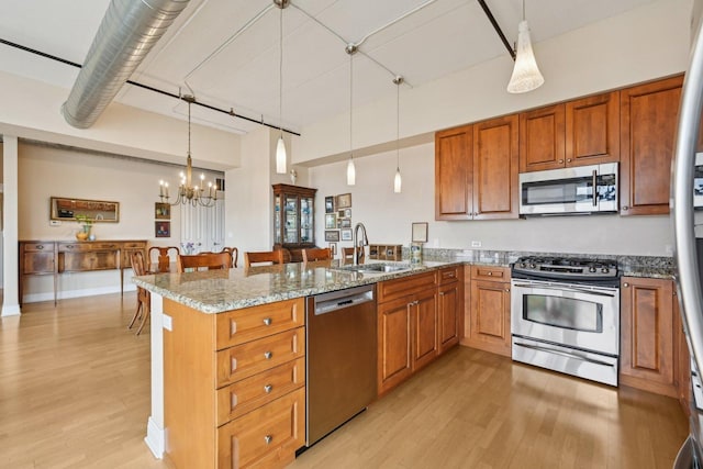 170 N NW Hwy Unit 401, Park Ridge, IL 60068 - kitchen featuring stainless steel appliances, a sink, a peninsula, light wood finished floors, and a chandelier