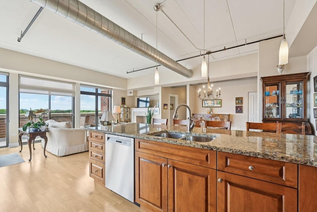 170 N NW Hwy Unit 401, Park Ridge, IL 60068 - kitchen featuring stainless steel dishwasher, a sink, brown cabinets, light wood-type flooring, and a chandelier