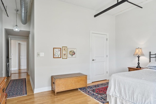 170 N NW Hwy Unit 401, Park Ridge, IL 60068 - bedroom featuring light wood-style floors, baseboards, and a towering ceiling