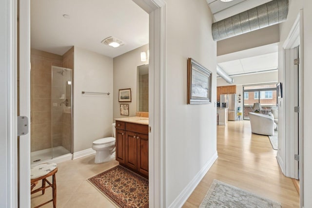 170 N NW Hwy Unit 401, Park Ridge, IL 60068 - full bathroom with vanity, a tile shower, toilet, wood finished floors, and baseboards