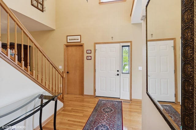 5 N Chestnut Ct, Hawthorn Woods, IL 60047 - entryway featuring light wood-style floors, stairs, a towering ceiling, and baseboards