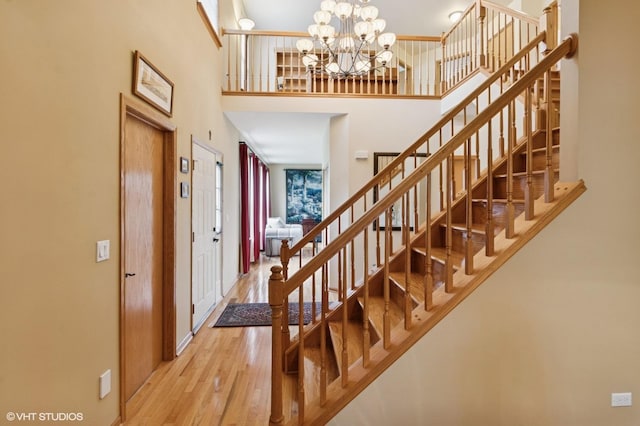 5 N Chestnut Ct, Hawthorn Woods, IL 60047 - foyer featuring a high ceiling, wood finished floors, baseboards, a chandelier, and stairway