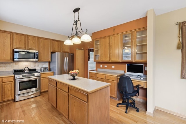 5 N Chestnut Ct, Hawthorn Woods, IL 60047 - kitchen with appliances with stainless steel finishes, light countertops, light wood-type flooring, a center island, and glass insert cabinets