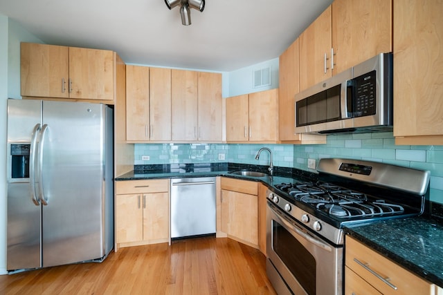 3200 N Lake Shore Dr Unit 911, Chicago, IL 60657 - kitchen featuring appliances with stainless steel finishes, a sink, light brown cabinets, and dark stone countertops